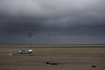 Boat dry at low tide on a mudflat Britain France