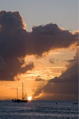 Sunset on the ocean and sailboat in Martinique Island
