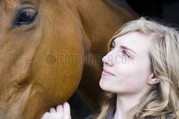 Girl stroking the head of a Horse France