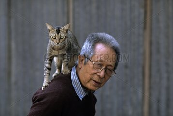 Cat on the shoulders of an old man Burma