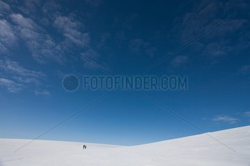 Hikers in the snow on the island Ammassalik Greenland