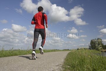 Rider on a road in the spring on Frisia Netherlands
