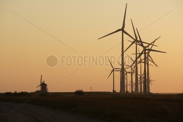 Mill and wind farm in Eemshaven at sunset Netherlands