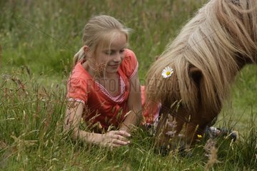 Girl with her Pony in a meadow Netherlands