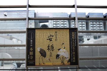Poster with cranes on the platform of Kyoto Station Japan