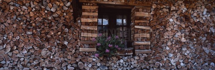 Wood arranged along one side of a mountain chalet