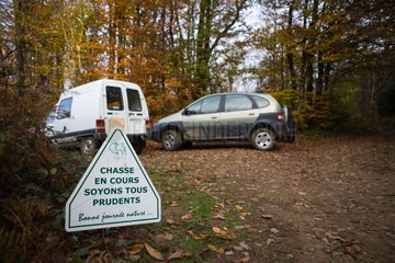 Cars in a hunting area indicated by a sign France