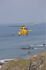 Helicopter air sea rescue on cliffs above Widemouth Bay UK