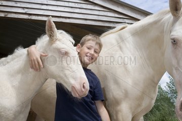 A boy with champagne cremelo Horses