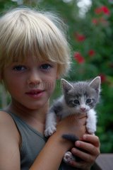 Boy holding a kitten France