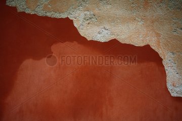 Wall covered with ocher damaged by weather France