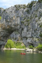 Canoe at the foot of the Pont d'Arc in the gorges of Ardeche