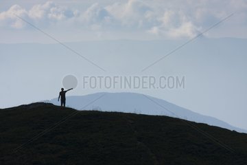 Silhouette of a man indicates a direction Belledone Alps