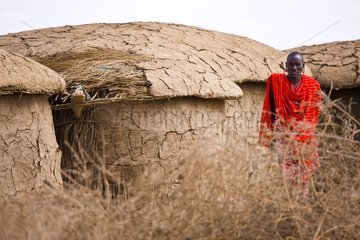 Masai man in front of hut Kenya