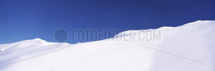 Snowy crest on a blue sky background Arêches village Savoie