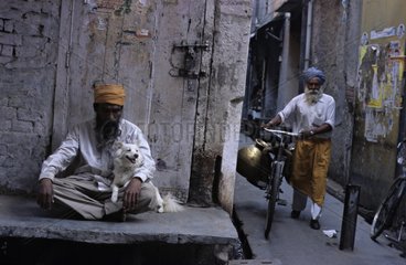 Man holding a dog sitting on his lap Amritsar India