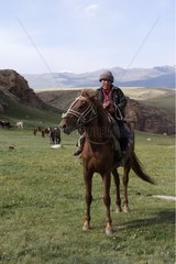 Nomadic child riding a horse in Kyrgyzstan