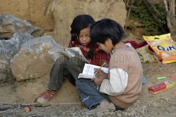 Moso girls doing their homework from school Yunnan