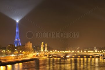 Paris under the mist and illuminated Eiffel Tower France
