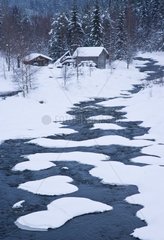 Houses and river in the taiga in winter Lapland Finland