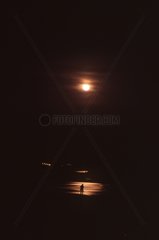 Mann in einem Spiegelbild der Mondfinsternis am Loire River Frankreich