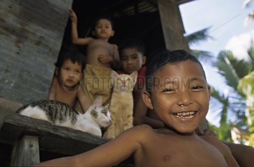 Portrait of children playing in a hut Cambodia