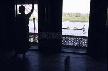 Silhouette of a cat and a monk Inle lake Burma
