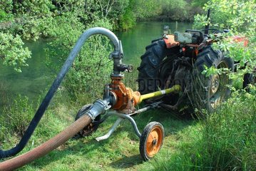 Pump plugged on a tractor near a river