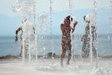 Children playing with public water jets