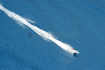 Speed-boat and its tracks drawing a diagonal