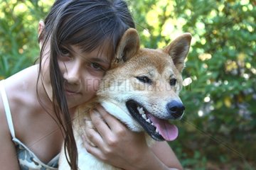 Portrait of a Girl and a Shiba Inu in a garden France