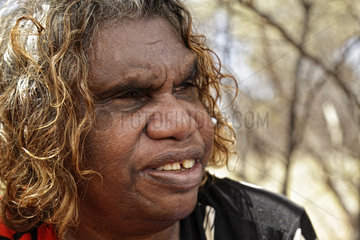 The Honey Ants Dream. Portrait of Audrey Martin  a 59-year-old Aborigine woman. Her mother's generation was the first to have contact with civilization and she still possesses the knowledge of the elders. Traditions are rapidly being lost and acculturation has been accelerating since contact with civilization. Learning about life in the desert had been gradual and depended on the youths' age. The secrets and the know-how were handed down as the person matured. The traditions linked to the boomerang were lost within one generation. Learning about and making the boomerang began when the youths were physically and spiritually ready. The elders have not been able to carry on this tradition. TV  video games  internet intensify acculturation. Northern Territory  Australia