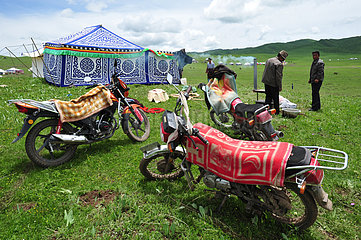 Motorcycles in a nomadic Tibetan herders camp - Tibet China