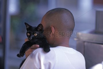 Buddhist nun wearing a black cat on his shoulder Burma