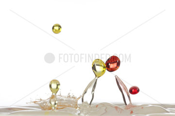 Drops of water colored on white background