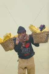 Indonesia  Java Island  East Java province  Kawah Ijen volcano  Miner carrying baskets of sulfur