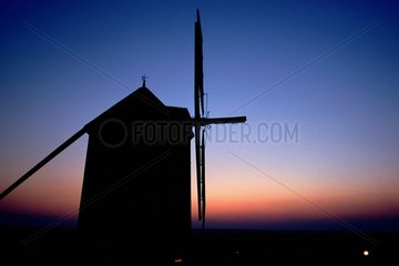 Silhouette of Windmills of Moidrey at twilight France