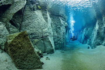 Scuba diver inside the volcanic crack Nesgjá  in the Ásbyrgi National Park  northern Iceland