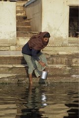 Femme prélevant de l'eau dans le Gange Inde