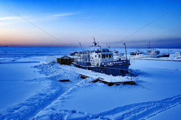 Diving boat blocked on the river Angara frozen  Irkutsk  Siberia  Russia