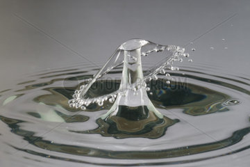 Single drop of water falling in water