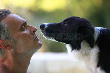 Man facing a one-year Border Collie