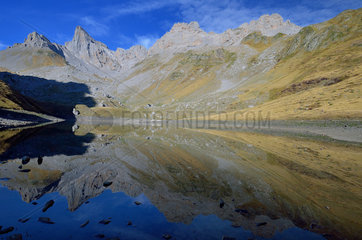 Reflections of the Table of Three Kings and Peaks of Peneblanque in the Lake of Lhurs. Aspe Valley  Pyrenees  France
