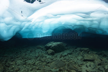 Dive under ice in a thawing mountain lake. Lac du Domenon. France  Isere (38)  Belledonne Massif