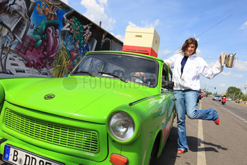 Urban Beekeeping - Erica Mayr  37 years old  posing with a Trabant  a hive and a smoker close to what is left of the Berlin Wall near Warschauer Strabe. Germany