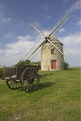 Restored French windmill with old cart Cherrueix Brittany