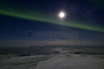 Full moon and aurora borealis over the Scoresbysund  Greenland  February 2016