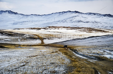 Car on a road from the island of Olkhon  Siberia  Russia