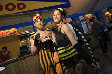 Urban Beekeeping - Pollination week in New York started with a costume ball on June 22  2009. A couple of bees out for a good time eat a hot-dog covered in honey-flavored mustard. Forbidden beekeeping is underground?but so chic? USA