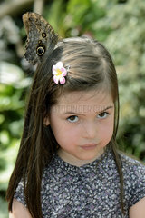 Morpho on the head of a girl - Butterfly Garden France